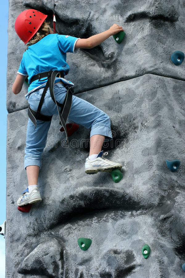 Pictur of kid from behind rock climbing
