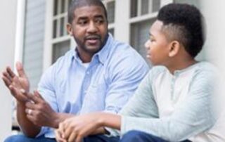 African american dad speaking to son