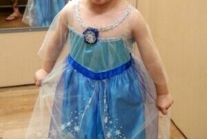 boy dressed in a blue Elsa character outfit