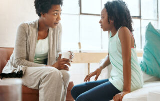 african american mother having what seems like a serious conversation with her tween daughter