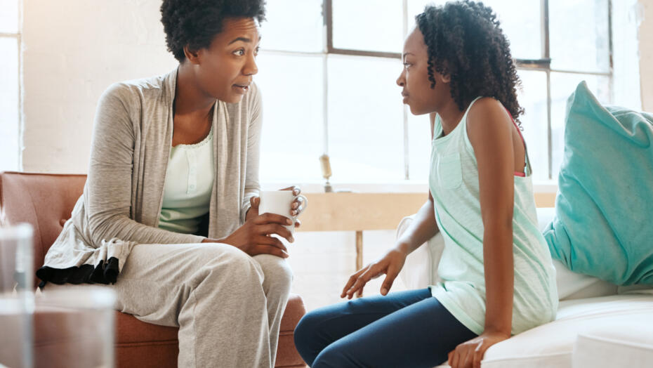 african american mother having what seems like a serious conversation with her tween daughter