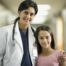 female physician with her arm around a young tween girl